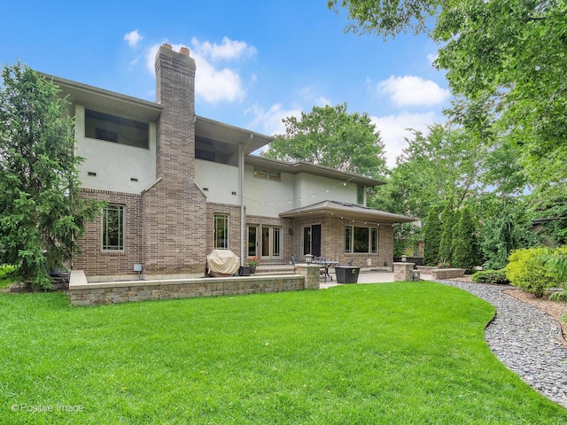 456 S Julian St, Naperville, IL 60540 - rear view of property with a patio, a lawn, brick siding, and a chimney