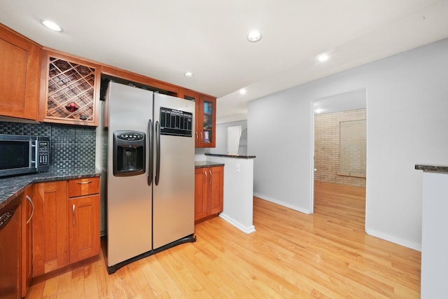 40 E 9th St Unit 1807, Chicago, IL 60605 - kitchen featuring appliances with stainless steel finishes, baseboards, decorative backsplash, light wood-style flooring, and recessed lighting