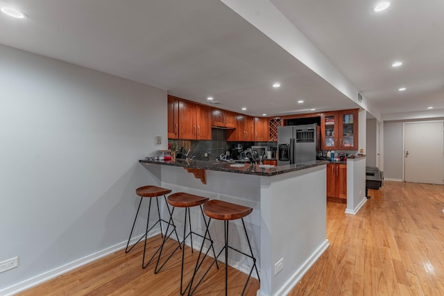 40 E 9th St Unit 1807, Chicago, IL 60605 - kitchen featuring fridge with ice dispenser, recessed lighting, a peninsula, baseboards, and light wood finished floors