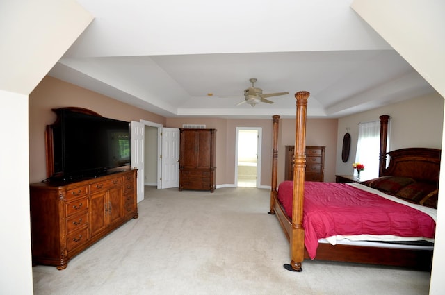 606 Reserve Ln, Joliet, IL 60431 - bedroom with a tray ceiling, light colored carpet, baseboards, connected bathroom, and ceiling fan