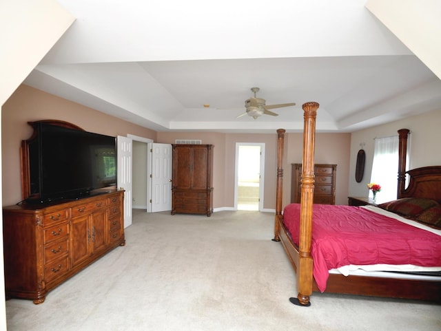 606 Reserve Ln, Joliet, IL 60431 - bedroom featuring a raised ceiling, light colored carpet, connected bathroom, and a ceiling fan
