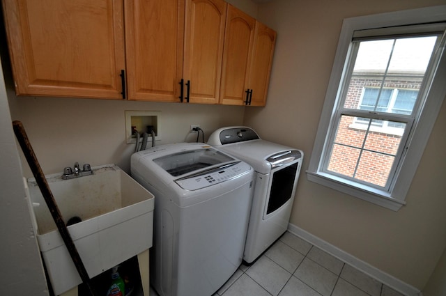 606 Reserve Ln, Joliet, IL 60431 - laundry room featuring independent washer and dryer, cabinet space, light tile patterned floors, and baseboards