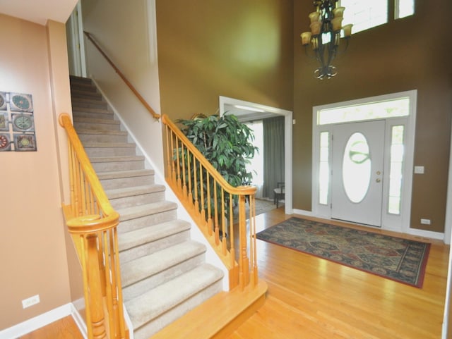 606 Reserve Ln, Joliet, IL 60431 - entryway featuring stairs, a chandelier, a towering ceiling, and wood finished floors