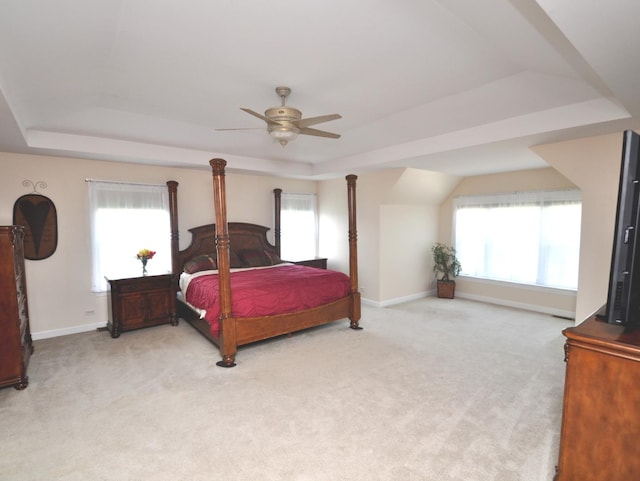 606 Reserve Ln, Joliet, IL 60431 - bedroom featuring a tray ceiling, light colored carpet, and a ceiling fan