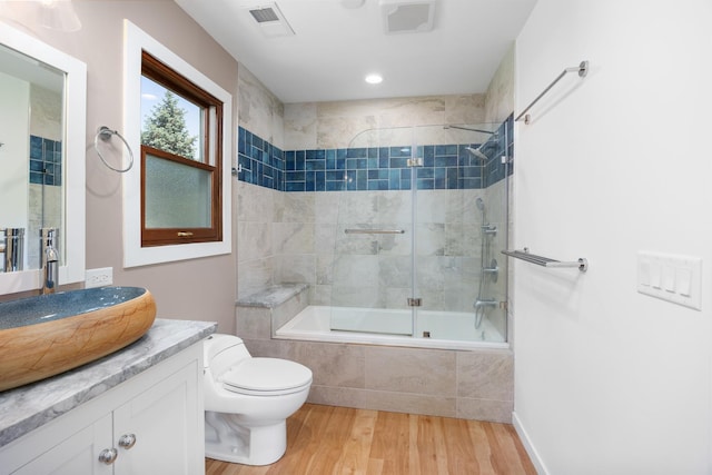 1125 Huntleigh Dr, Naperville, IL 60540 - bathroom with tiled shower / bath, wood finished floors, vanity, and toilet