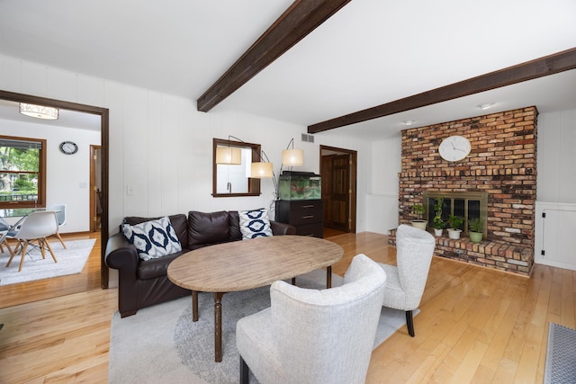 1125 Huntleigh Dr, Naperville, IL 60540 - living area with light wood-style floors, beamed ceiling, a decorative wall, and a fireplace