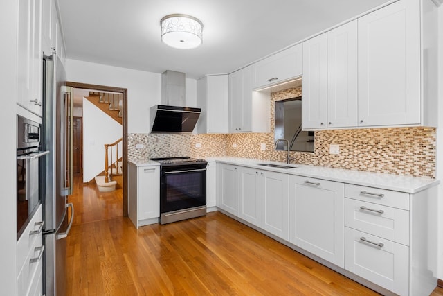 1125 Huntleigh Dr, Naperville, IL 60540 - kitchen with range, a sink, light countertops, light wood-style flooring, and white cabinetry