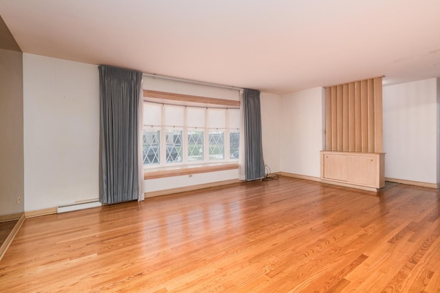 8560 W Winona St, Chicago, IL 60656 - unfurnished room featuring light wood-type flooring and a baseboard heating unit