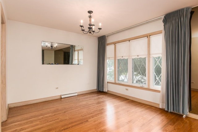 8560 W Winona St, Chicago, IL 60656 - unfurnished room featuring a chandelier, light wood-style flooring, and a baseboard heating unit