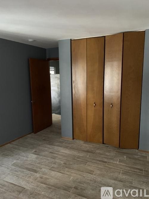 unfurnished bedroom with a closet and wood finished floors