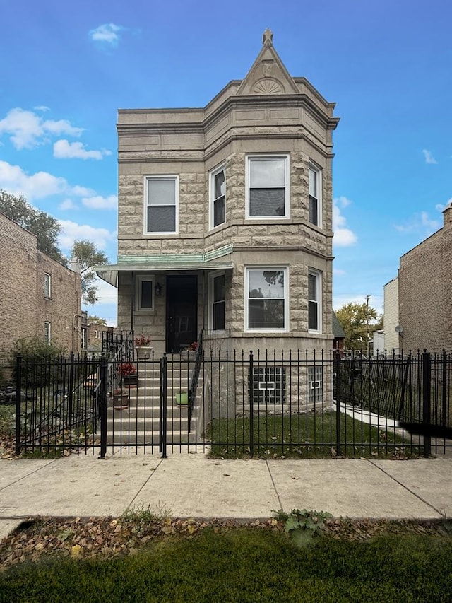 4032 W Wilcox St, Chicago, IL 60624 - view of front of home with stone siding and a fenced front yard