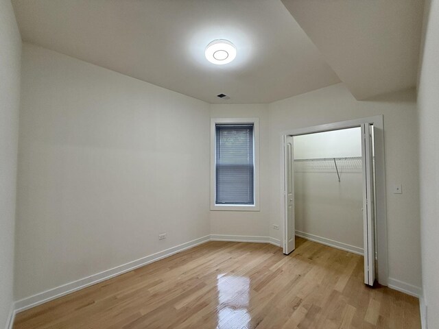 4032 W Wilcox St, Chicago, IL 60624 - unfurnished bedroom featuring light wood finished floors, a closet, and baseboards
