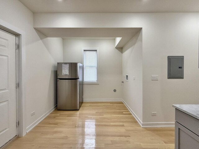 4032 W Wilcox St, Chicago, IL 60624 - laundry room with electric panel, light wood finished floors, baseboards, and hookup for a washing machine