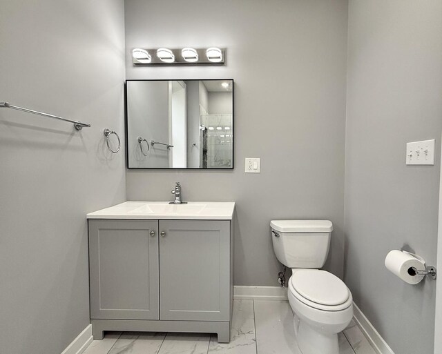 4032 W Wilcox St, Chicago, IL 60624 - bathroom with marble look tiles, baseboards, vanity, and toilet