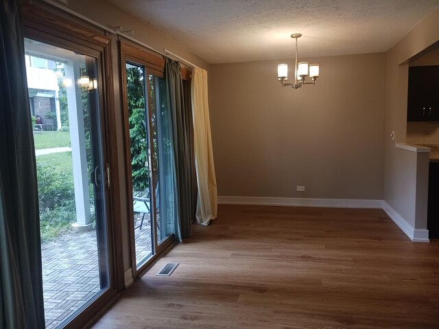 366 Pinetree Ln Unit B1, Schaumburg, IL 60193 - unfurnished dining area with healthy amount of natural light, baseboards, and wood finished floors