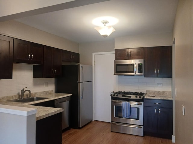 366 Pinetree Ln Unit B1, Schaumburg, IL 60193 - kitchen with stainless steel appliances, a sink, tasteful backsplash, and dark brown cabinets