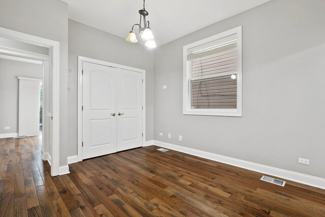1505 N Talman Ave Unit 1, Chicago, IL 60622 - unfurnished dining area featuring baseboards, dark wood-style flooring, and a chandelier
