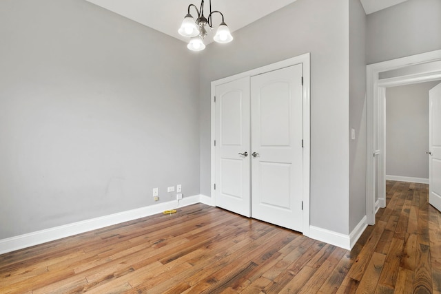 1505 N Talman Ave Unit 1, Chicago, IL 60622 - unfurnished dining area with a chandelier, wood-type flooring, and baseboards