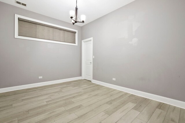 1505 N Talman Ave Unit 1, Chicago, IL 60622 - spare room with a chandelier, light wood-style flooring, and baseboards