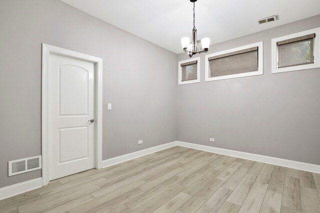 1505 N Talman Ave Unit 1, Chicago, IL 60622 - empty room featuring a chandelier, light wood-type flooring, and baseboards