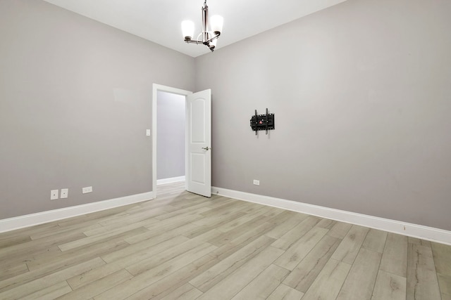 1505 N Talman Ave Unit 1, Chicago, IL 60622 - empty room with a chandelier, baseboards, and light wood finished floors