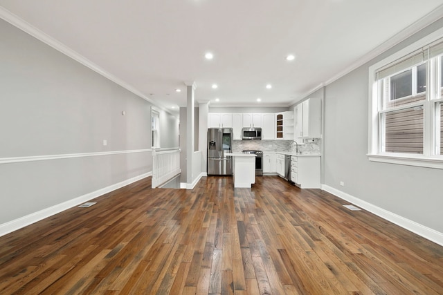 1505 N Talman Ave Unit 1, Chicago, IL 60622 - unfurnished living room featuring crown molding, dark wood-type flooring, baseboards, recessed lighting, and a sink