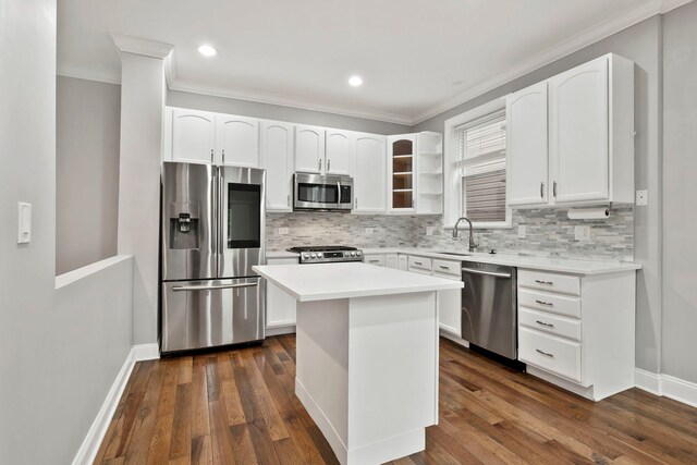 1505 N Talman Ave Unit 1, Chicago, IL 60622 - kitchen featuring appliances with stainless steel finishes, ornamental molding, a sink, tasteful backsplash, and white cabinetry