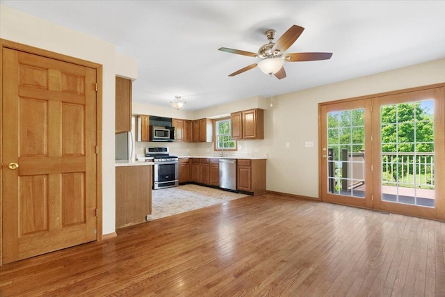 1132 10 Pin Ln, Beach Park, IL 60099 - kitchen featuring stainless steel appliances, brown cabinets, light countertops, light wood finished floors, and ceiling fan