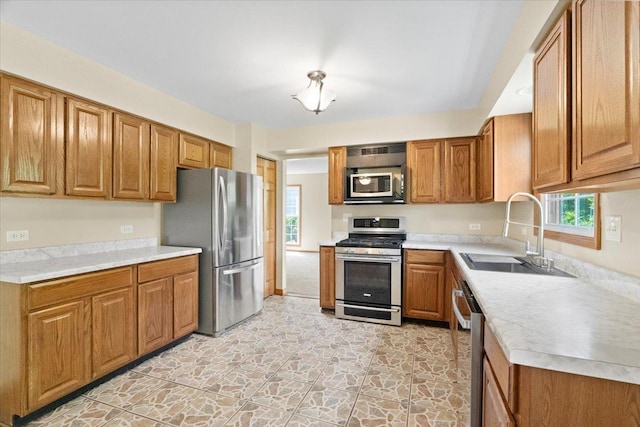 1132 10 Pin Ln, Beach Park, IL 60099 - kitchen featuring appliances with stainless steel finishes, a sink, and brown cabinets