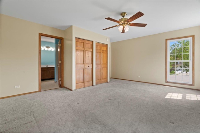 1132 10 Pin Ln, Beach Park, IL 60099 - unfurnished bedroom featuring multiple closets, carpet flooring, baseboards, ensuite bathroom, and ceiling fan