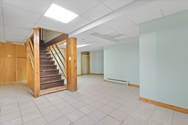 1132 10 Pin Ln, Beach Park, IL 60099 - finished basement featuring a baseboard heating unit, a paneled ceiling, stairway, and light tile patterned floors