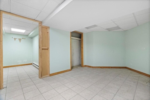 1132 10 Pin Ln, Beach Park, IL 60099 - finished basement featuring a paneled ceiling, a baseboard radiator, and baseboards