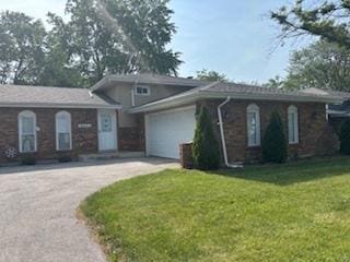 18644 Aberdeen St, Homewood, IL 60430 - tri-level home featuring driveway, an attached garage, and a front yard
