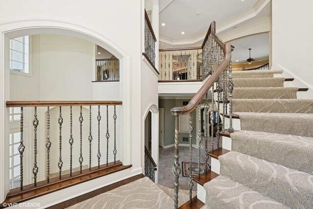 29026 N Brassie Ct, Ivanhoe, IL 60060 - staircase featuring arched walkways, crown molding, a towering ceiling, recessed lighting, and wood finished floors