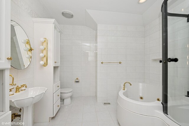 29026 N Brassie Ct, Ivanhoe, IL 60060 - bathroom featuring a tub with jets, tile walls, toilet, and tile patterned floors