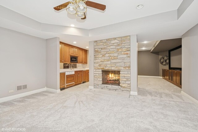 29026 N Brassie Ct, Ivanhoe, IL 60060 - unfurnished living room with light colored carpet, a ceiling fan, baseboards, a stone fireplace, and recessed lighting