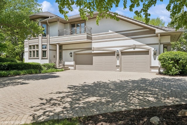 29026 N Brassie Ct, Ivanhoe, IL 60060 - view of front of house featuring a balcony, decorative driveway, stucco siding, and a tiled roof