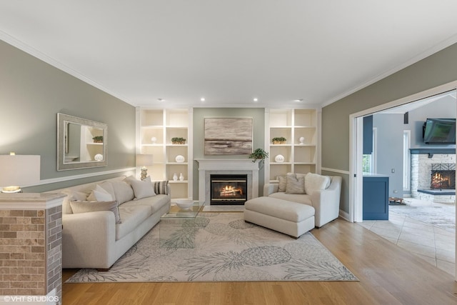 6724 Greene Rd, Woodridge, IL 60517 - living room with a warm lit fireplace, wood finished floors, crown molding, built in features, and recessed lighting