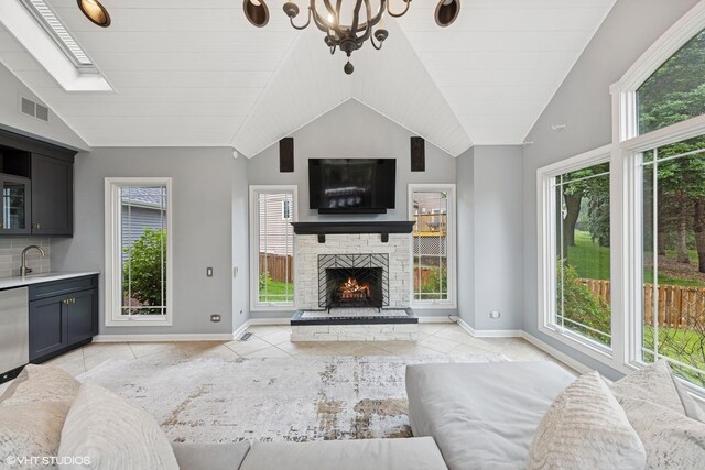 6724 Greene Rd, Woodridge, IL 60517 - unfurnished living room featuring vaulted ceiling, light tile patterned floors, healthy amount of natural light, a stone fireplace, and baseboards