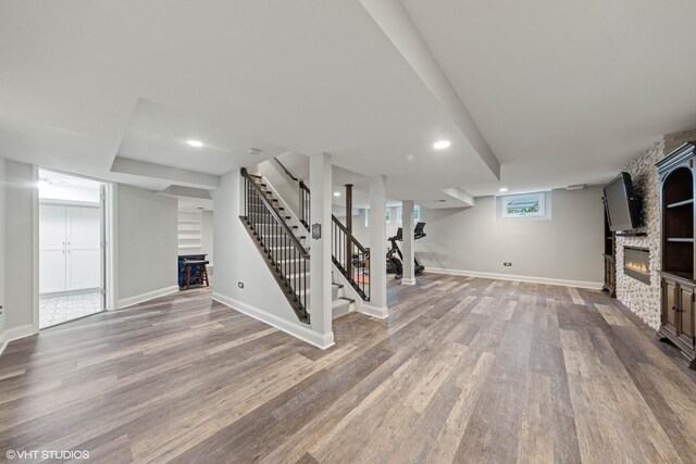6724 Greene Rd, Woodridge, IL 60517 - below grade area featuring a fireplace, wood finished floors, stairs, baseboards, and recessed lighting