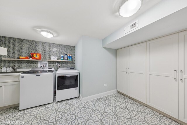 6724 Greene Rd, Woodridge, IL 60517 - washroom featuring washing machine and dryer, cabinet space, and baseboards
