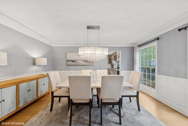6724 Greene Rd, Woodridge, IL 60517 - dining space featuring wood finished floors, ornamental molding, a chandelier, and a wainscoted wall