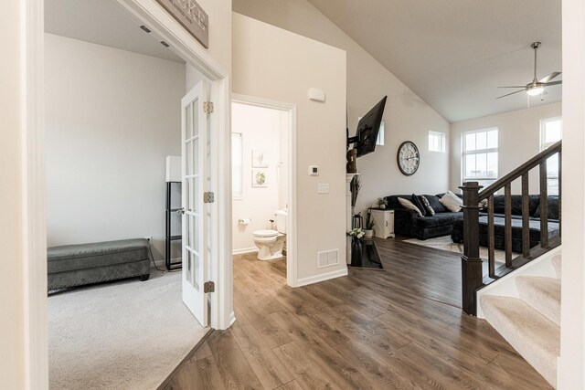 1125 Juniper Dr, Sycamore, IL 60178 - hall featuring wood finished floors, vaulted ceiling, stairs, and baseboards