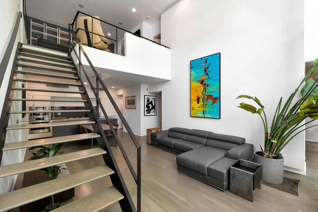 839 N Hermitage Ave Unit 101, Chicago, IL 60622 - stairway with wood finished floors, a towering ceiling, and baseboards