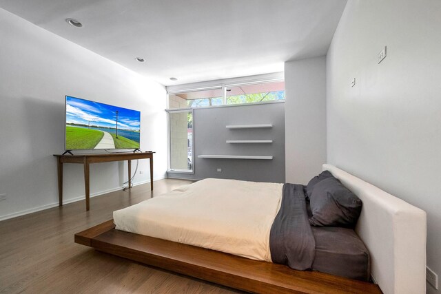 839 N Hermitage Ave Unit 101, Chicago, IL 60622 - bedroom with wood finished floors, baseboards, and recessed lighting