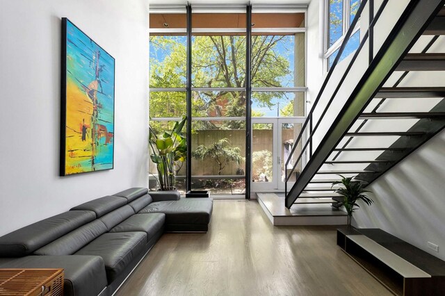 839 N Hermitage Ave Unit 101, Chicago, IL 60622 - living area with wood finished floors, stairway, and a wall of windows