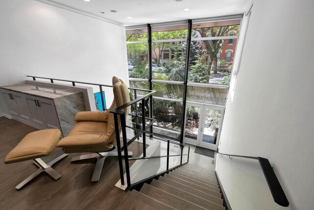 839 N Hermitage Ave Unit 101, Chicago, IL 60622 - stairs featuring floor to ceiling windows, wood finished floors, healthy amount of natural light, and recessed lighting