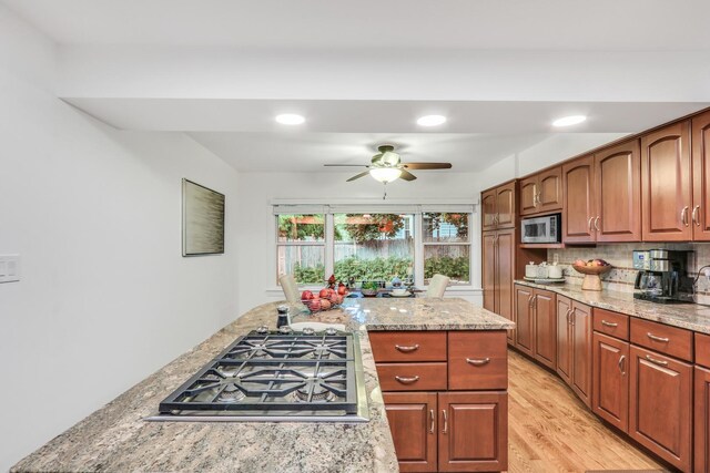 2310 Malik Ct, Glenview, IL 60025 - kitchen with appliances with stainless steel finishes, a ceiling fan, light wood finished floors, recessed lighting, and light stone countertops
