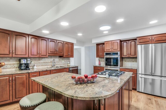 2310 Malik Ct, Glenview, IL 60025 - kitchen featuring appliances with stainless steel finishes, a sink, backsplash, light wood-style flooring, and recessed lighting