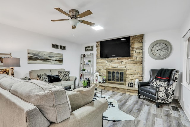 2310 Malik Ct, Glenview, IL 60025 - living room with a ceiling fan, wood finished floors, and a stone fireplace